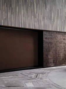 A textured, metal wall panel with a modern design in a contemporary interior space.