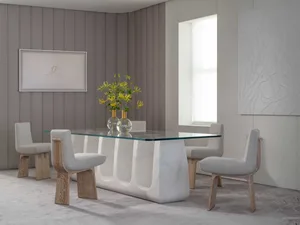 Modern dining room featuring a sleek glass top dining table with a marble base and white wooden chairs.