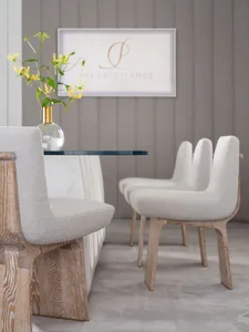 A spa interior with white leather seating and wooden frames.