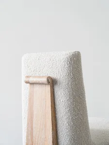 A modern chair with a wooden frame and textured fabric upholstery.