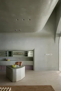 A modern retail space featuring concrete shelves and minimalist design
