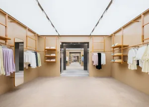 A clothing retail store featuring a minimalist design with wood accents.