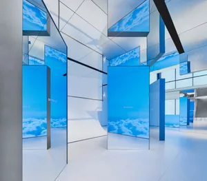 Minimalist interior design featuring glass mirrors and reflective surfaces.