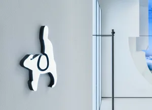 A minimalist metal icon mounted on a wall.