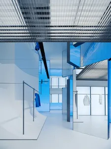 Modern minimalist retail store interior with glass and metallic finishes.