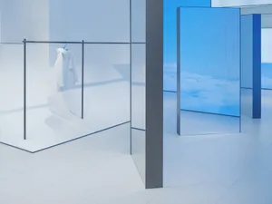 A minimalist retail storefront with glass walls and a white interior.