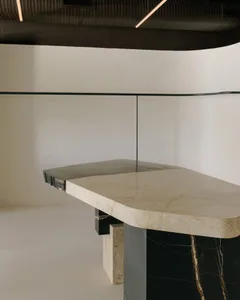 A modern interior design featuring marble surfaces and sleek, minimalist furniture.