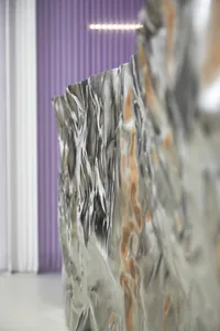 A metallic panel with a modern design and textured surface.