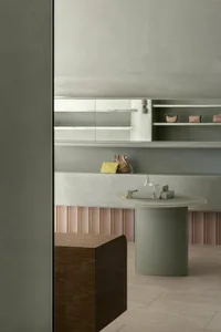 A modern retail store featuring minimalist design with concrete and wooden finishes.