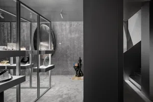 Modern, minimalistic retail store display featuring glass and concrete materials.