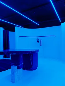 Modern interior with marble furniture and bright blue lighting