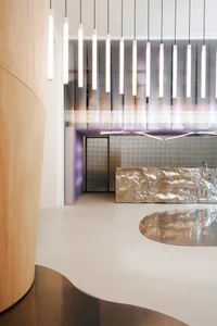 A modern interior space featuring metallic details and a textured metallic surface.