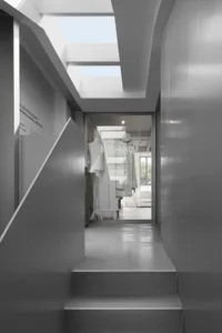 Modern minimalist interiors featuring large glass elements and sleek design.