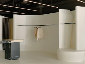 Minimalist retail store interior with smooth white surfaces and black marble accents