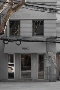 Modern retail storefront with concrete and glass facade.