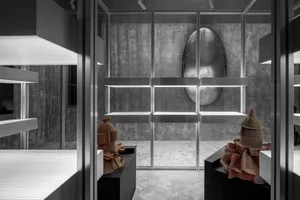 Minimalist interior with concrete walls, white lighting, and modern decor.