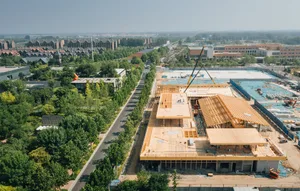 A view of a construction site in progress, featuring the wooden frame of a building.