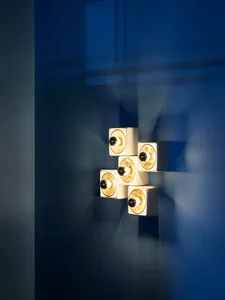 Minimalist interior design featuring sleek, white porcelain cubes with warm bulbs.