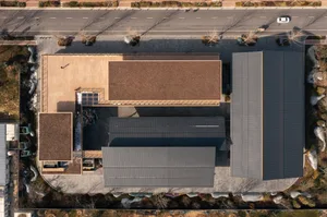 A modern building with concrete and metal exterior materials.
