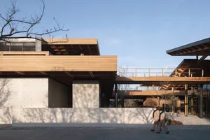 Modern building exterior with a wooden facade, featuring clean lines and a minimalist architectural design.
