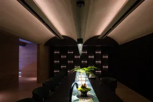 A sleek, modern industrial restaurant bar with metal accents and a minimalist interior design.
