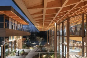 A modern interior design featuring wooden beams and glass walls.