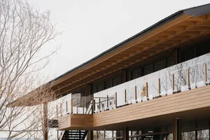Modern residential exterior featuring wooden and glass materials.