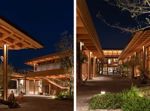 Modern homes featuring wooden architecture at night.