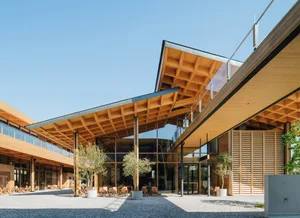 Modern exterior of a restaurant with wooden elements and a glass facade.