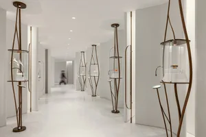 A modern retail store with metal shelving units displaying glass products.