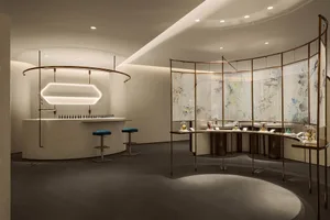 Interior design image showcasing a modern retail space with glass walls and a minimalist bar area.