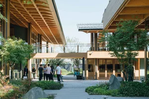Modern storefront with glass walls and wooden finishes, featuring specialty shop elements.