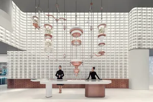 A minimalist retail space featuring white walls, glass and metal fixtures, and hanging glass floral displays.