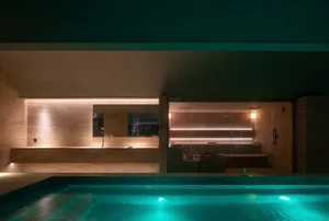 Modern spa interior with a swimming pool and sauna suite