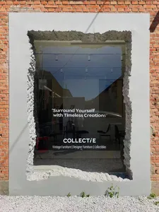 Modern retail storefront with glass windows and exposed concrete walls.