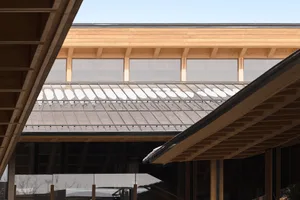 Modern building with wooden roof featuring marble tiles.