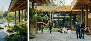Modern minimalist building with wooden exterior and glass walls surrounded by greenery.
