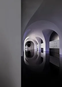 A modern architectural interior design with reflective surfaces and symmetrical arches.