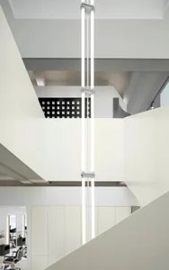 Modern hotel suite featuring glass walls and concrete floor