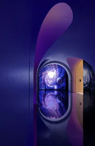 A modern architectural interior with a glass archway and a view of a galaxy.