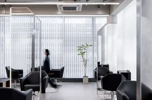 Modern interior space featuring glass, concrete, and metal