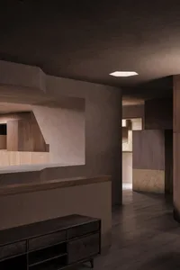 Minimalist interior design featuring wood and concrete elements.