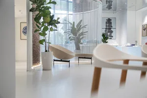 An image showing a modern office space featuring minimalist furniture and contemporary design elements.