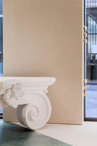 Modern interior design featuring decorative plaster elements on a wall.