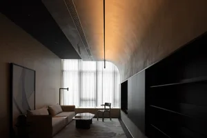 Modern living room featuring metallic furniture and glass elements.