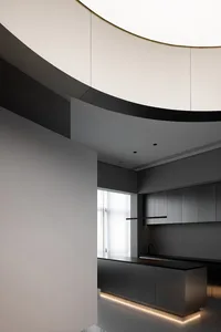 A modern minimalist kitchen featuring grey metallic cabinets and sleek design elements.