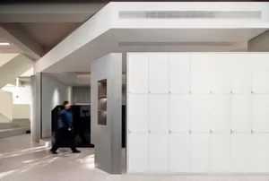 A modern office interior featuring concrete walls and a minimalist design.