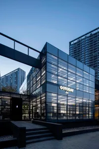 Modern office building exterior with glass facade and illuminated signage