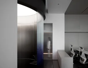 Privacy cubicle with glass and steel walls and floor, providing modern architectural design elements.
