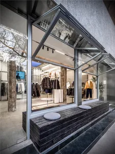 Modern retail storefront featuring glass and concrete elements.